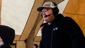 Student broadcasting game with headset on